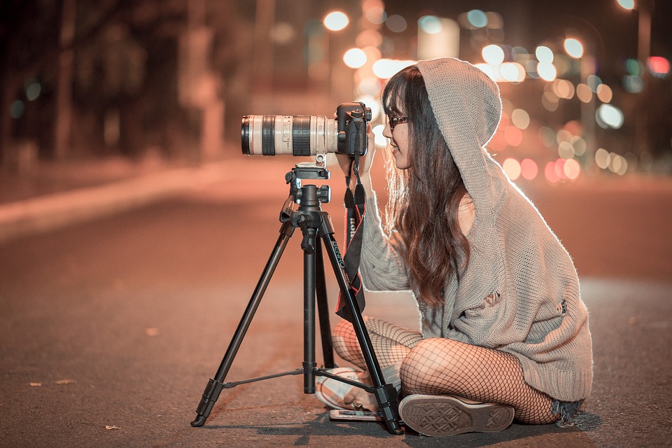 A beautiful woman taking a shot of her camera